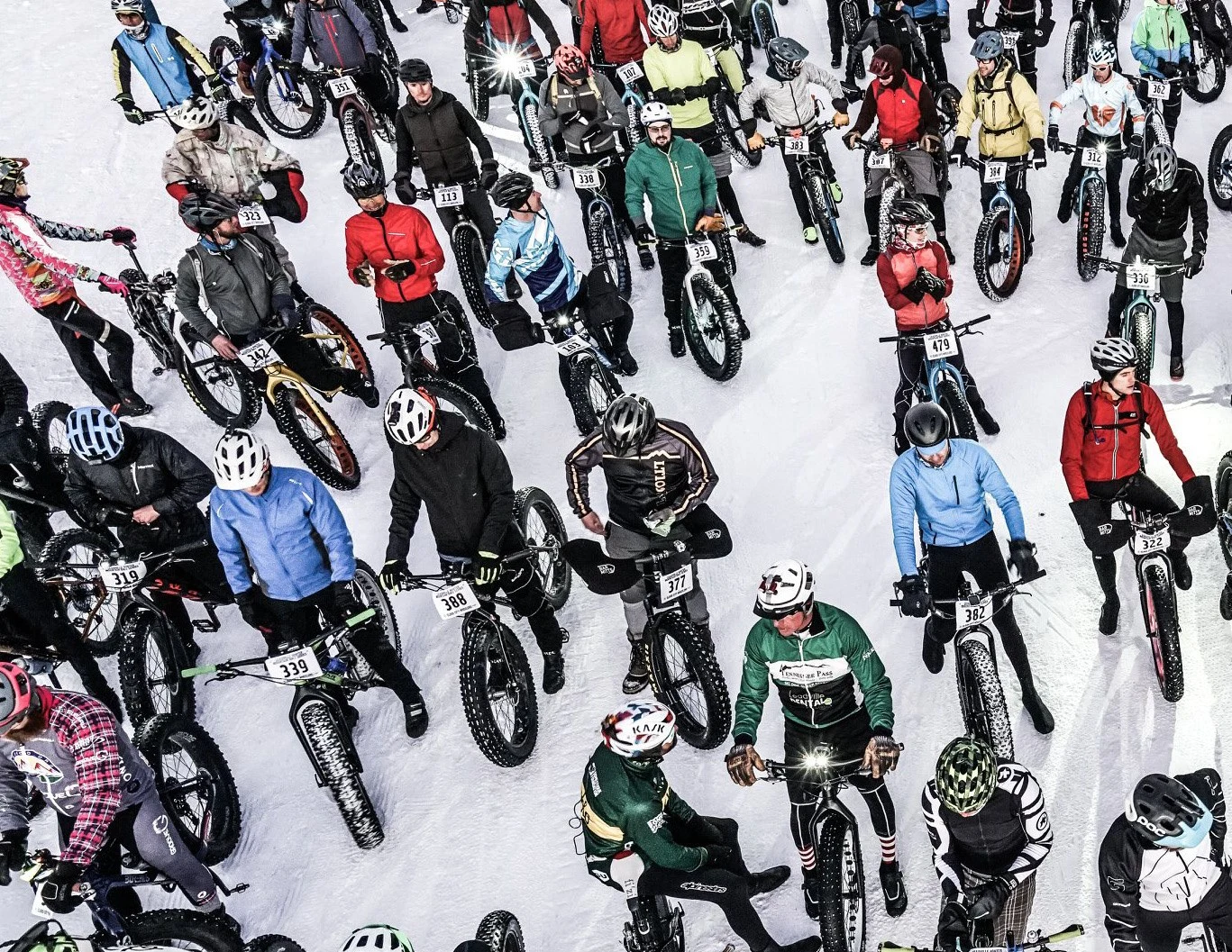 Fat-bike riders gather on the snow at a Wheelers winter event.